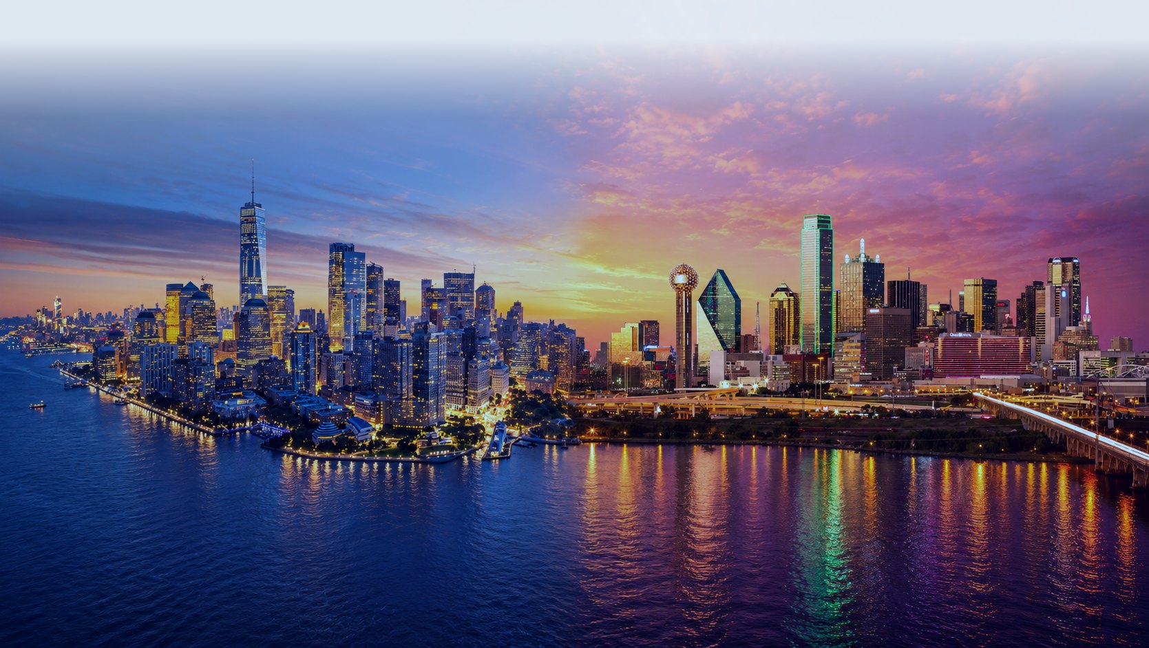 Downtown skyline along the water, with a pale sky above the towers.